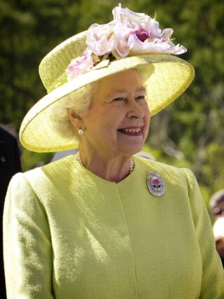 Queen Elizabeth II in yellow jacket and hat