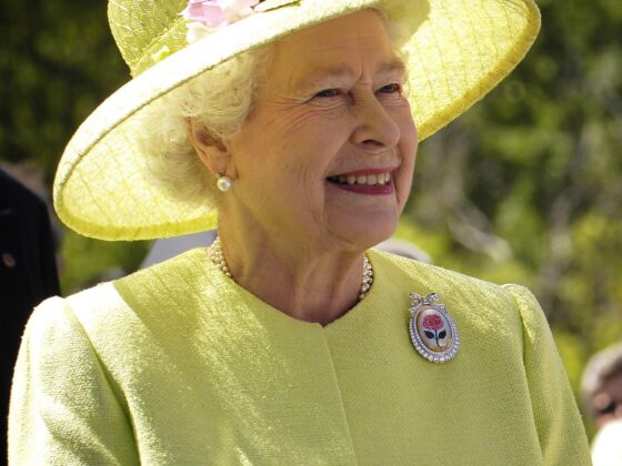 Queen Elizabeth II in yellow jacket and hat