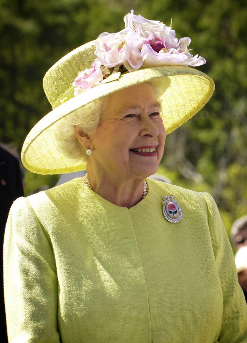 Queen Elizabeth II in yellow jacket and hat