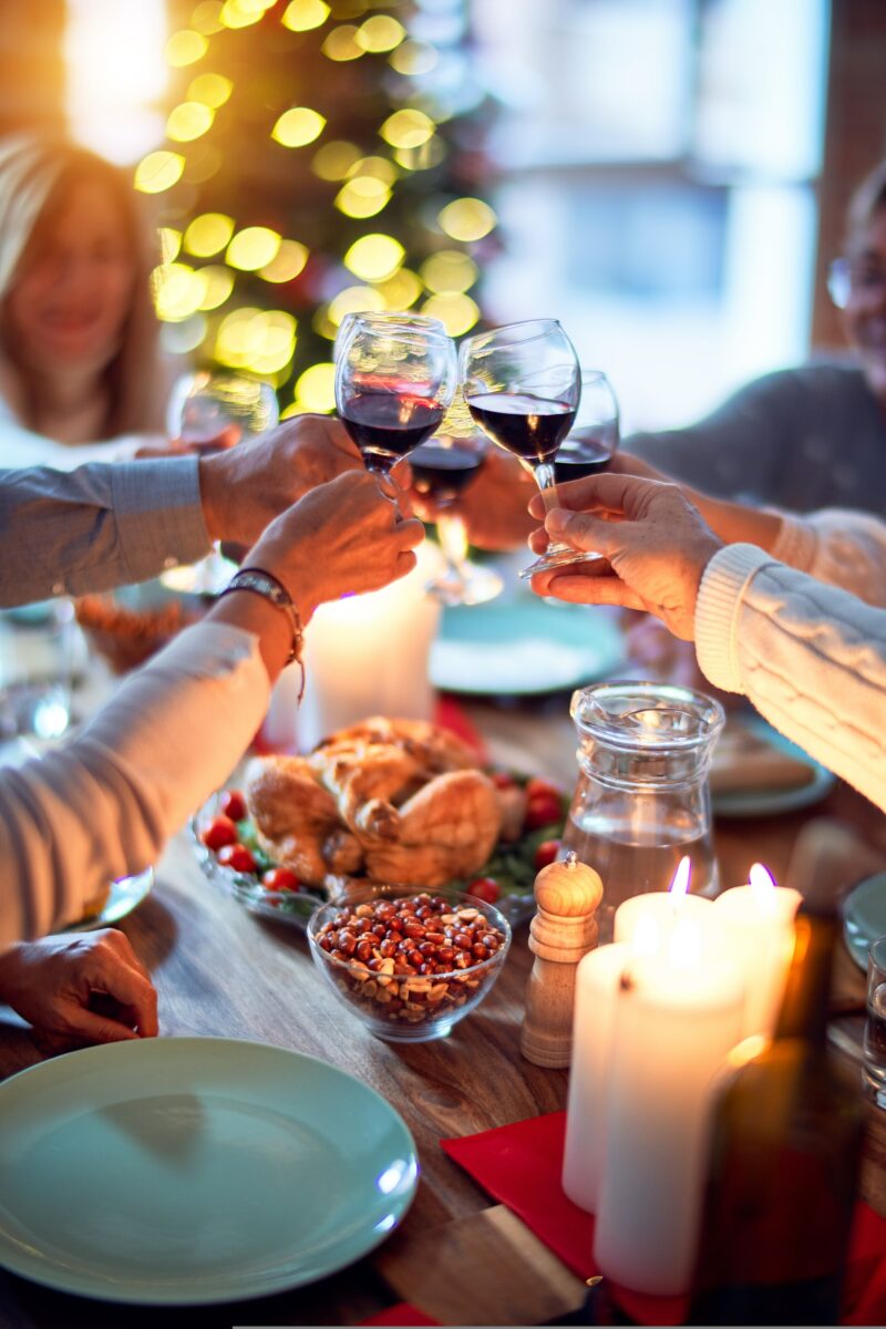 Friends clinking together glasses of wine